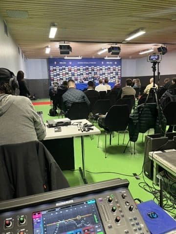 Press room at Ullevaal stadium during a match, with people in the room and a mixing desk in the foreground